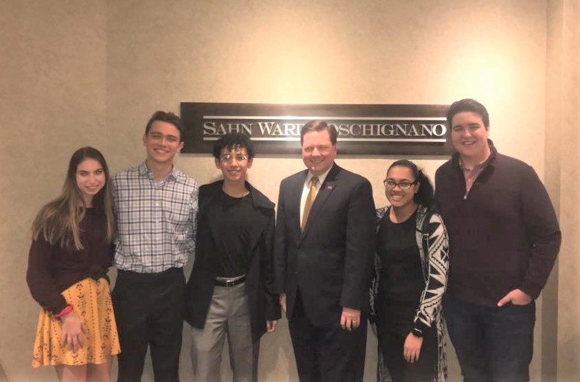 Tom McKevitt (third from right), Counsel with the Firm, poses with the members of the Holy Trinity Diocesan High School Moot Court Team at the Firm's Uniondale office. 